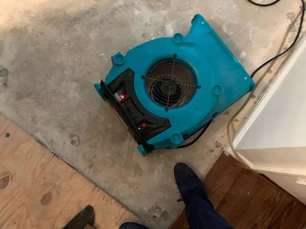 Air mover drying subfloor during Commercial Water Damage Restoration in Pine Bluff
